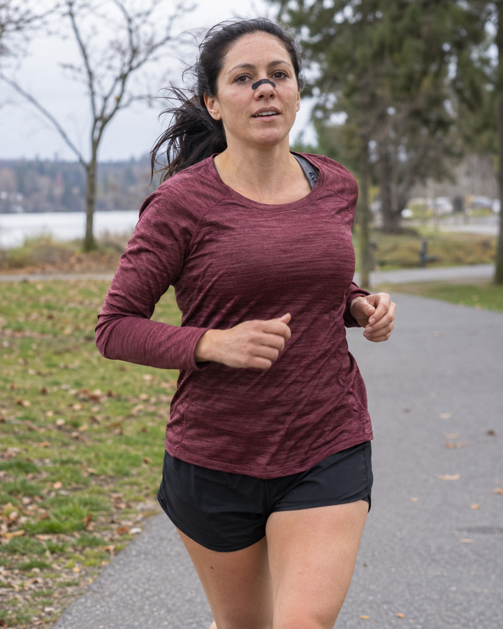 Generated lifestyle illustration: Woman jogging outdoors wearing a black nasal strip
